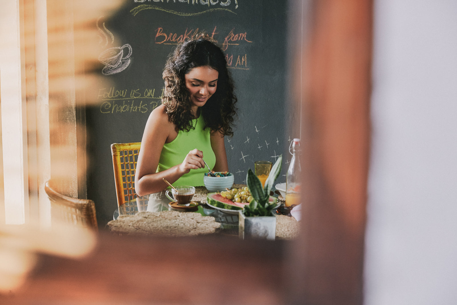 Image of girl eating breakfast at a table.