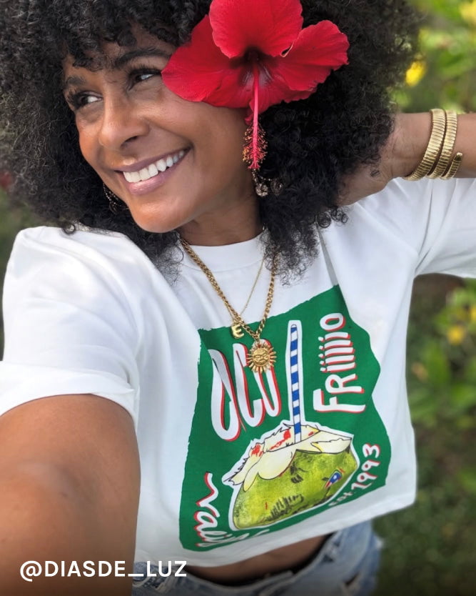 Woman wearing a white t-shirt with a green graphic design outdoors